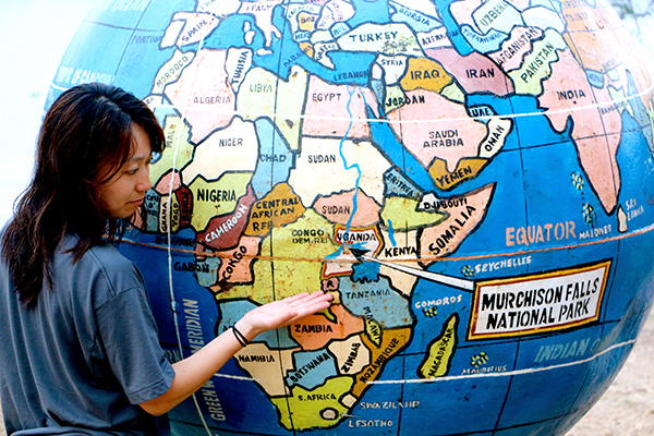 woman pointing at a map of africa