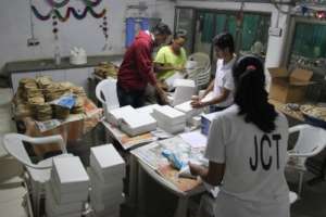 Volunteers packing the food in packets